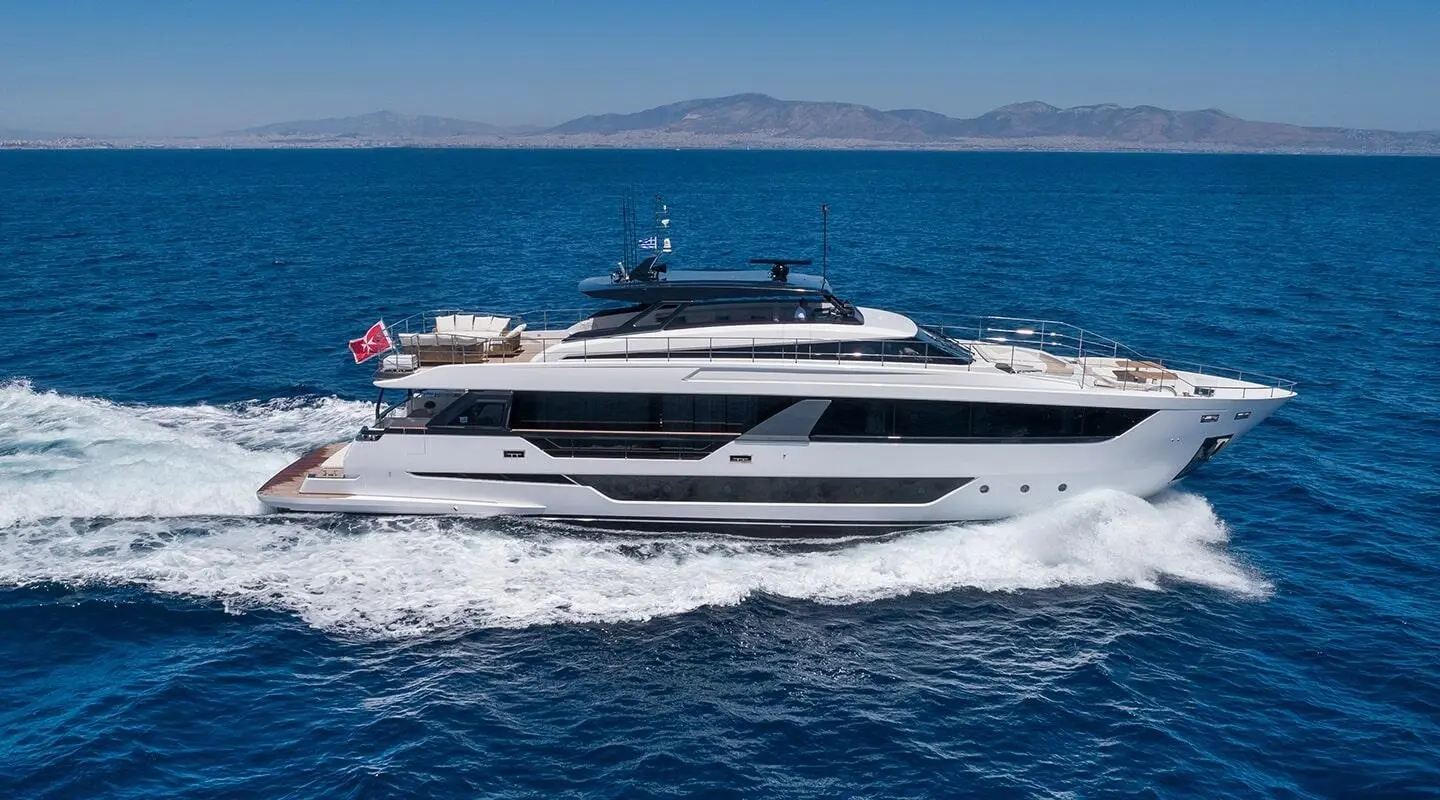 White luxury motor yacht cruising through deep blue sea