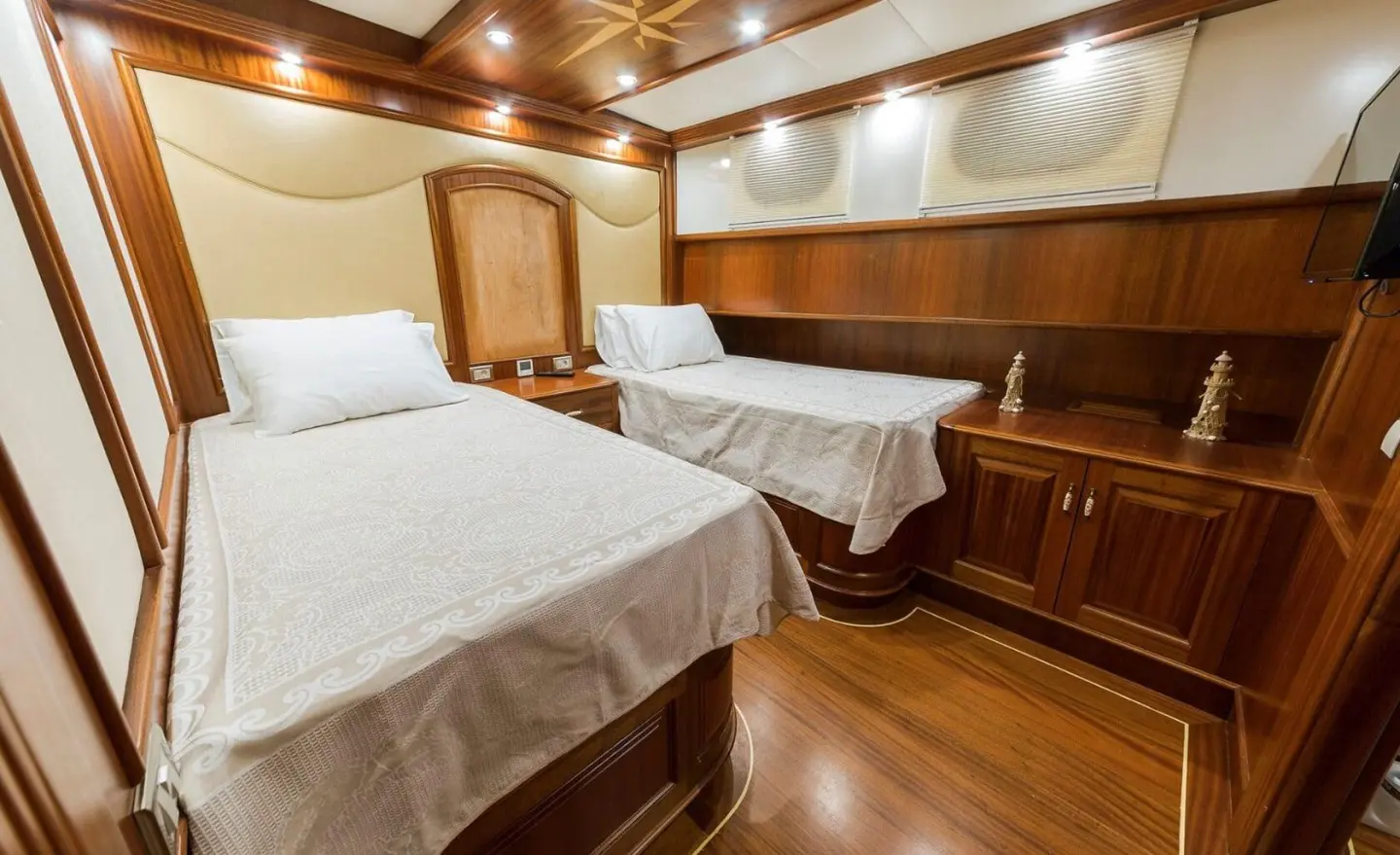 Interior of Halcon Del Mar gulet with twin cabins, wooden furnishings and beds
