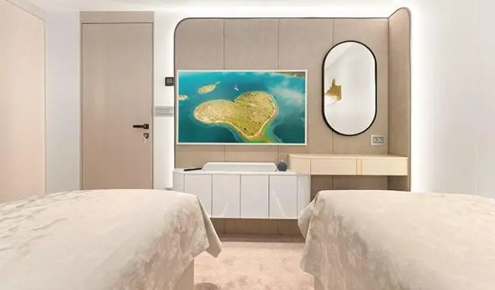 Twin cabin with ensuite on Maxita yacht, bed, wood cabinetry, and TV