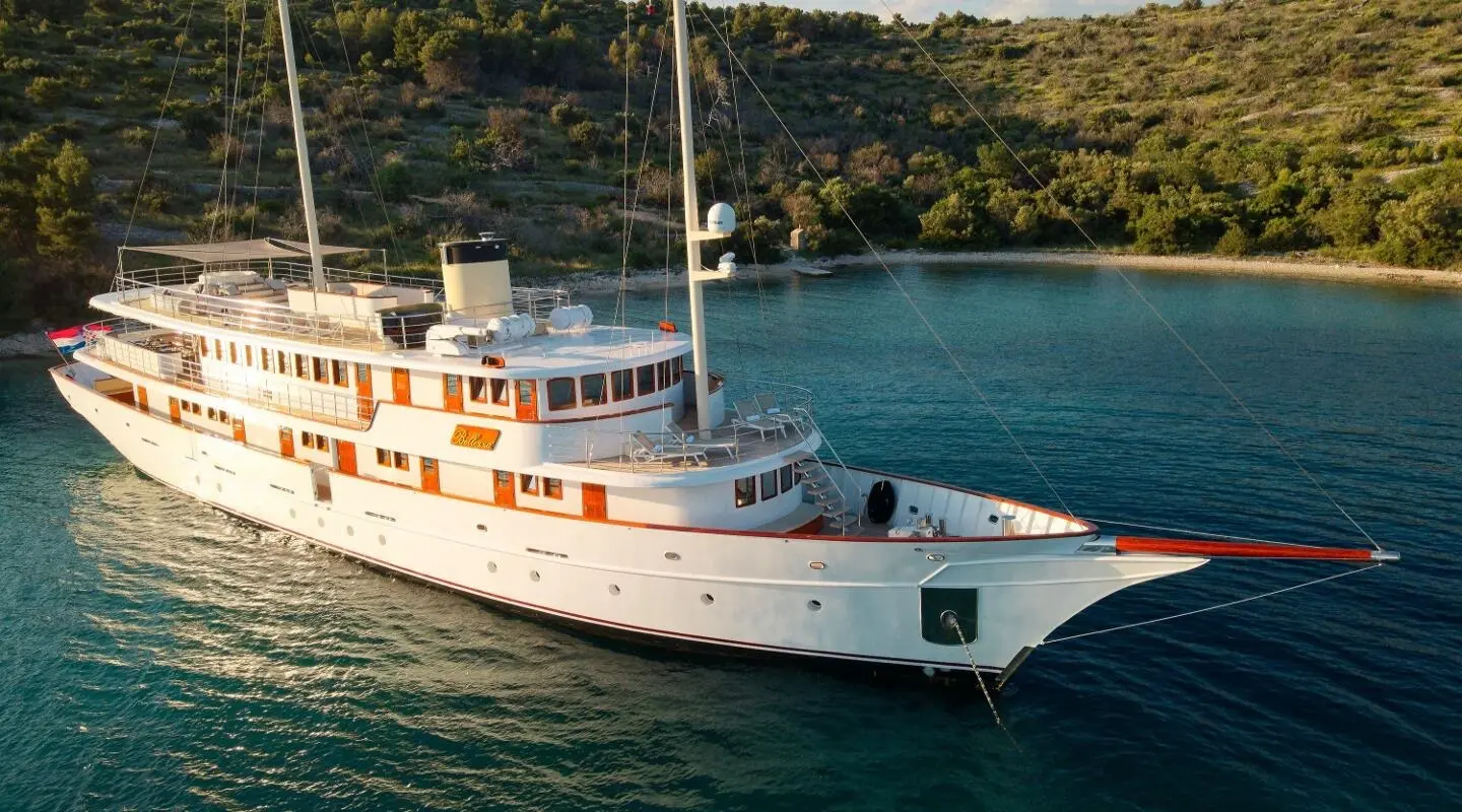 White luxury yacht Bellezza anchored on blue sea, side view from aerial angle