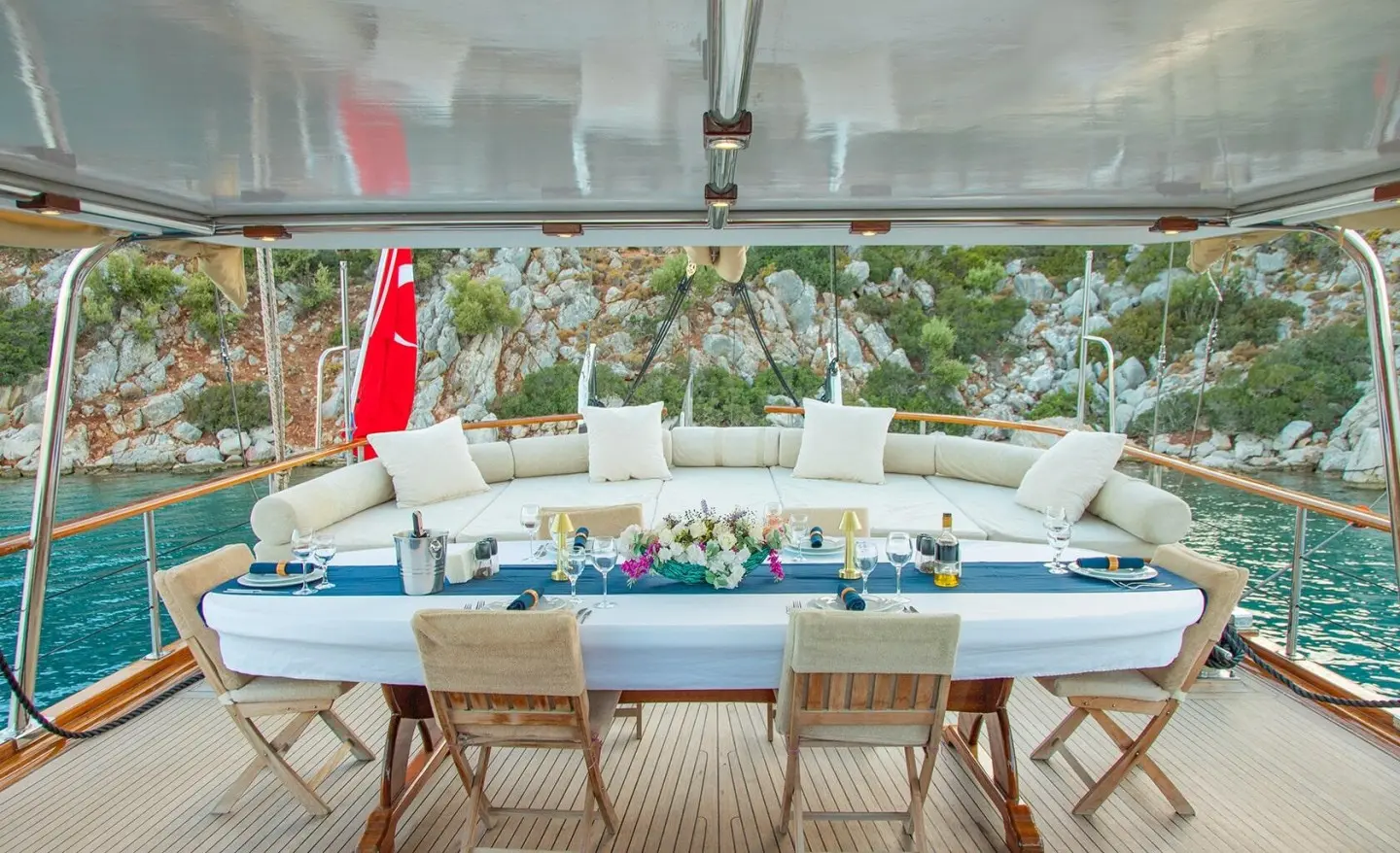 Gulet Derin Deniz aft deck seating area with blue cushions and dining table