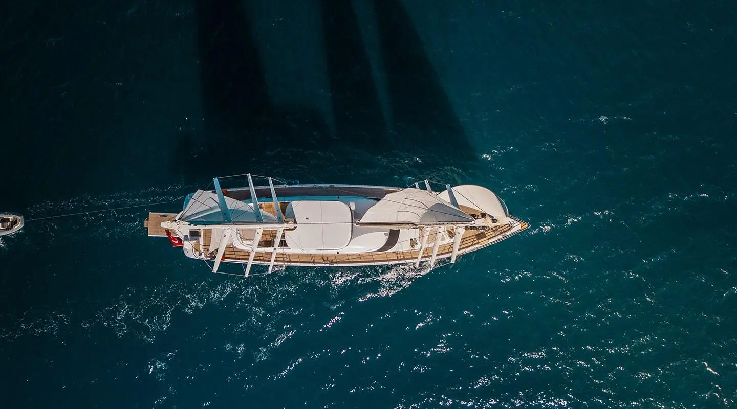 Angelo III yacht seen from above anchored in calm blue sea at sunset