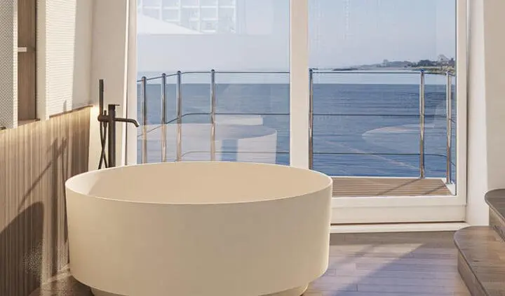 Yacht Bello master cabin ensuite with white seating and deck window view
