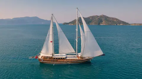 Lycian Queen luxury gulet anchored on blue water at sunset