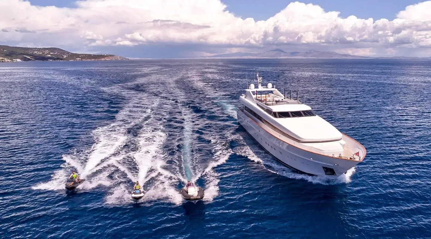 A luxury Mobius yacht sails at sea with another speedboat nearby