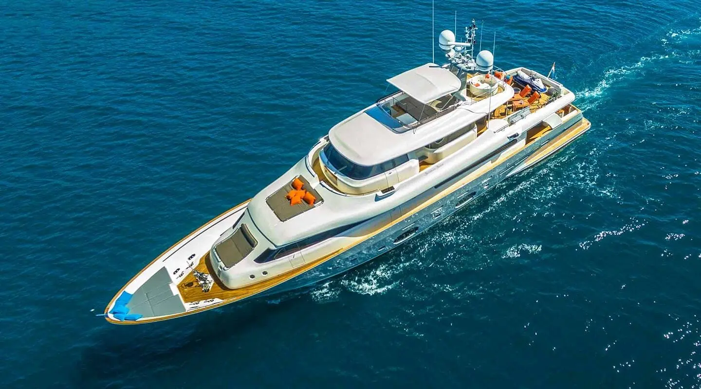 Aerial view of a sleek yacht named Seventh Sense cruising on blue sea