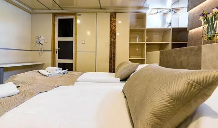 Melody yacht master cabin with king bed and ensuite bathroom visible
