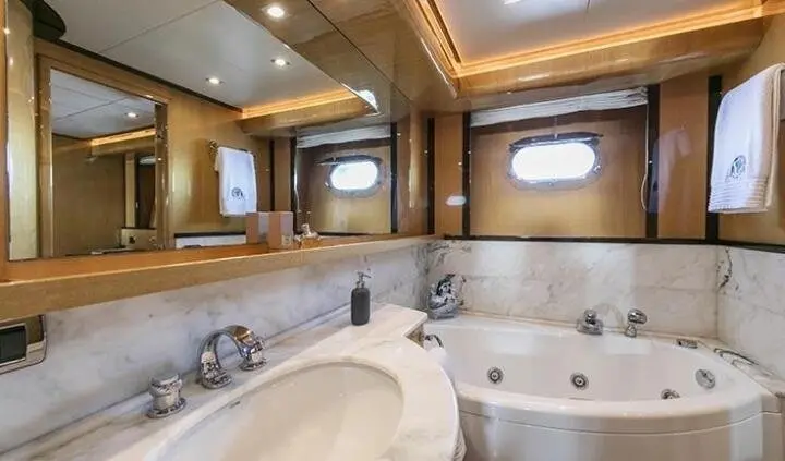 Master cabin with king bed, ensuite bath, wood paneling, porthole window
