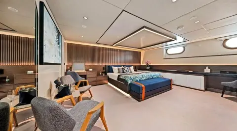 Interior of Anima Maris yacht with lounge chairs and built-in seating