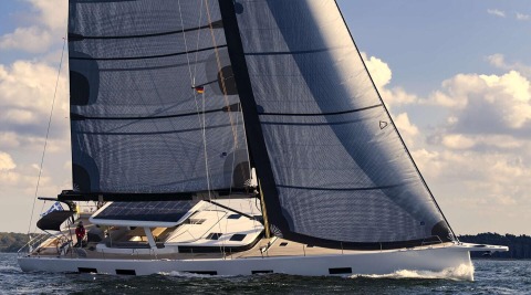Sunlit sailing yacht Nadamas glides in open water with large sails, people on the starboard side and a solar panel on the deck