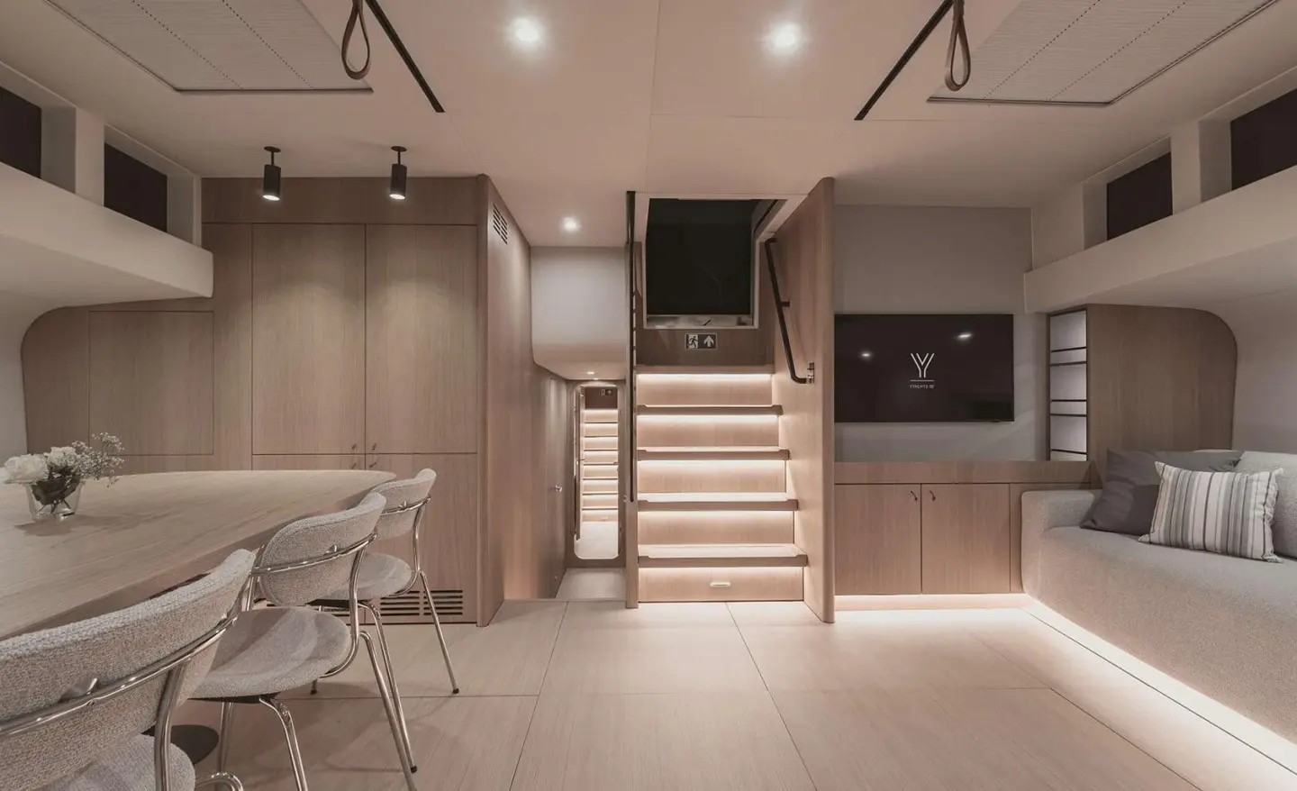 Nadamas yacht saloon with dining table, chairs and stairs