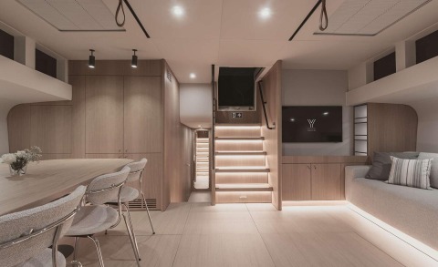 Nadamas yacht saloon with dining table, chairs and stairs