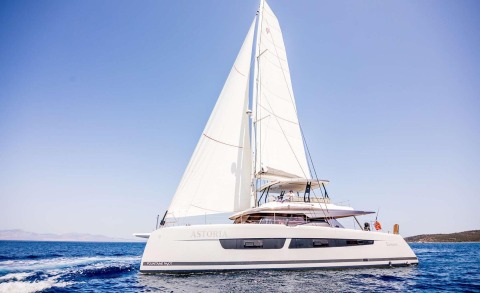 Sailing yacht on the water with two people on the upper deck
