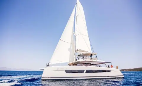 Sailing yacht on the water with two people on the upper deck