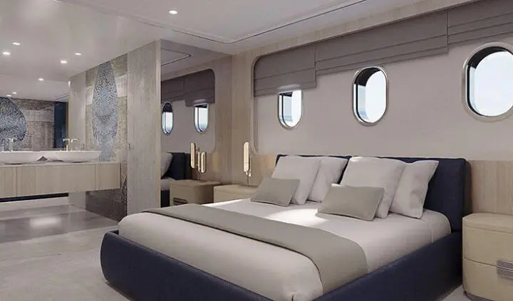 Maia master cabin with king bed, neutral linens, porthite windows, built-in seating