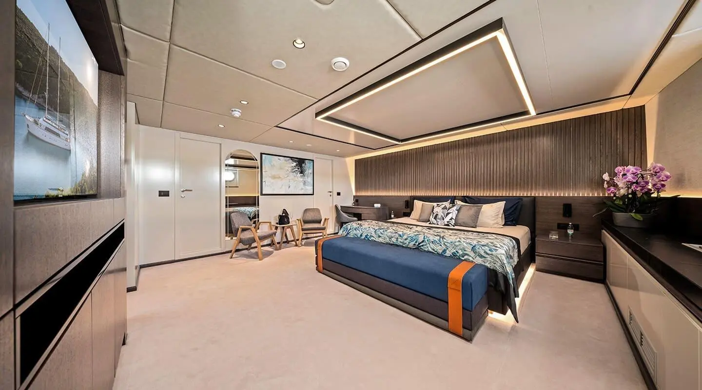Luxurious yacht Anima Maris master cabin with blue bedding and modern seating