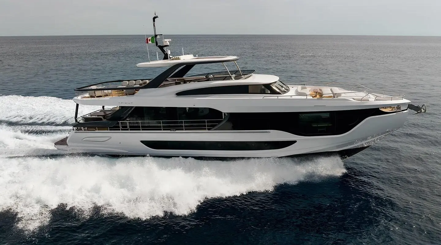 Viva II motor yacht cruising on blue sea with wake and clear sky