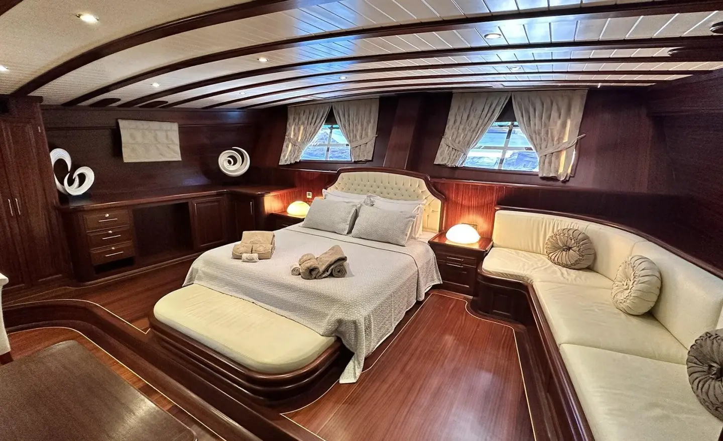 Luxurious yacht Arif Kaptan A interior with large cream beds and polished wood flooring