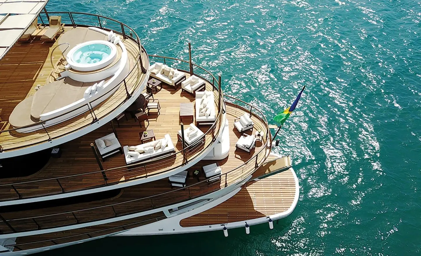 Aerial view of Chakra motor yacht anchored in turquoise sea with deck seating