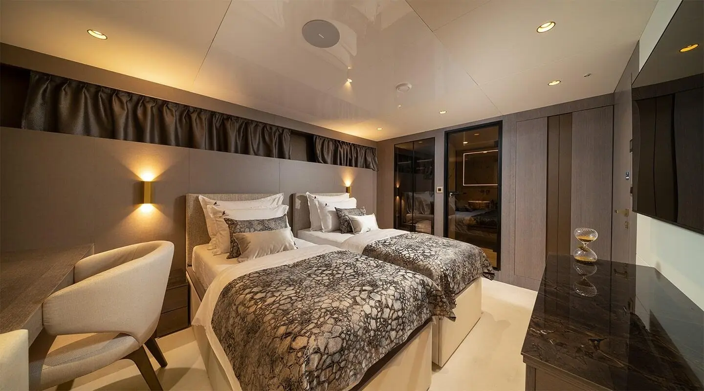 Nocturno luxury yacht twin beds suite with textured bedding and ambient wall lights