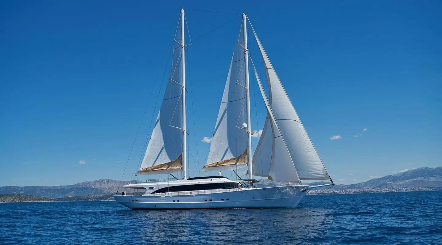 White luxury sailing yacht Acapella on blue sea with sails raised