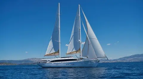 White luxury sailing yacht Acapella on blue sea with sails raised