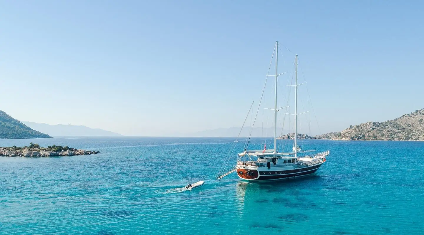 luxe gulet Vista Mare anchored in calm blue sea near rocky coastline