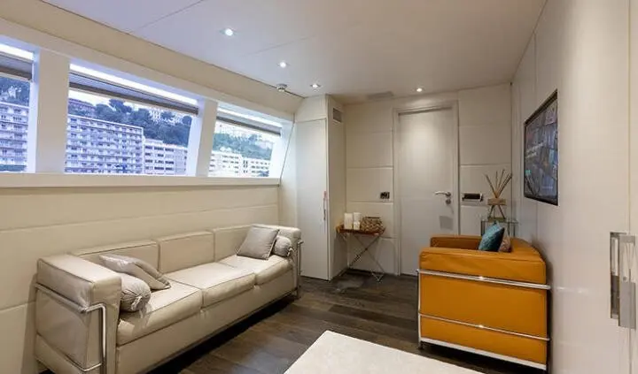 Bright master cabin with king bed, ensuite door, windows, and seating