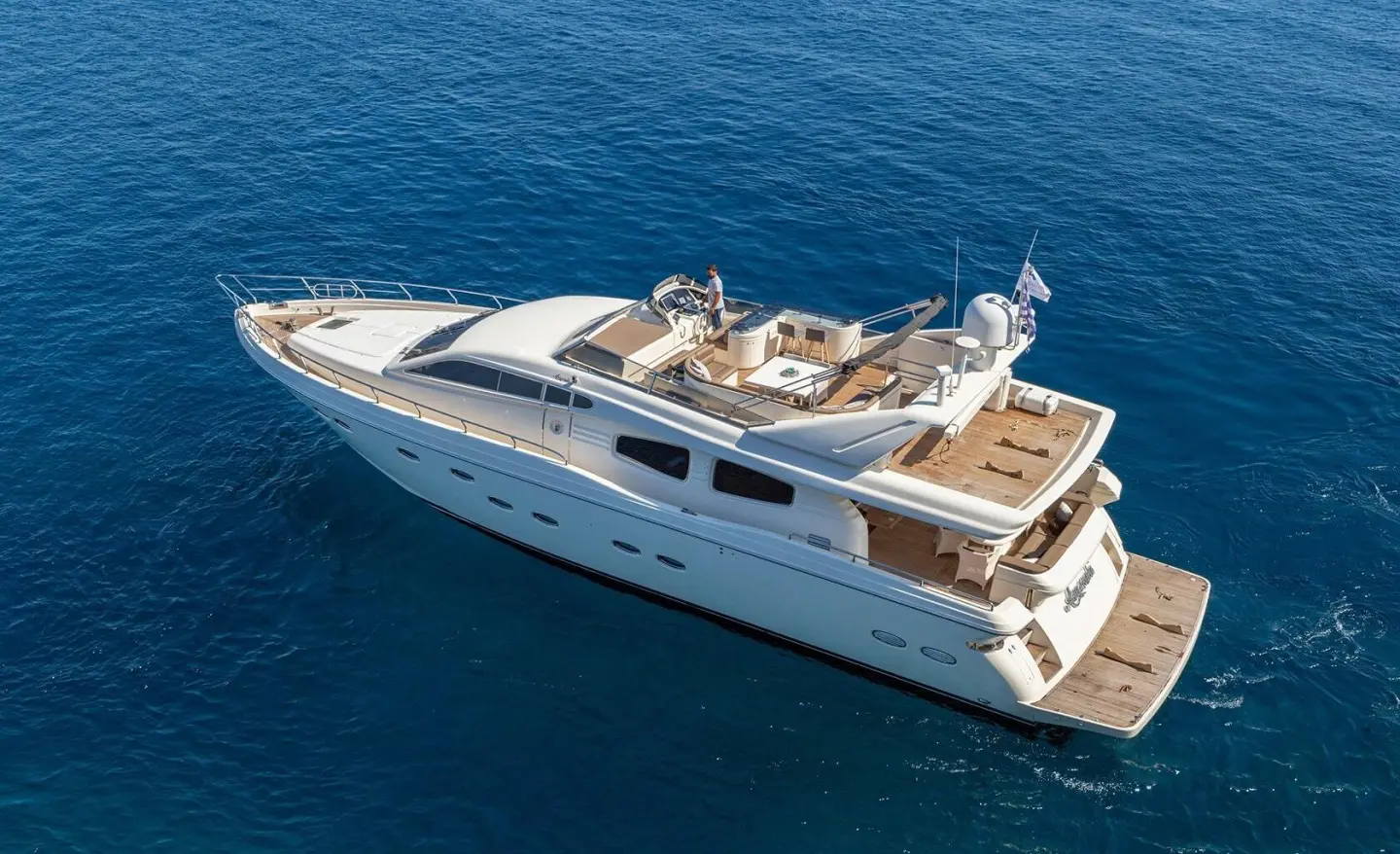 Aerial view of Amoraki luxury motor yacht cruising blue sea, white hull