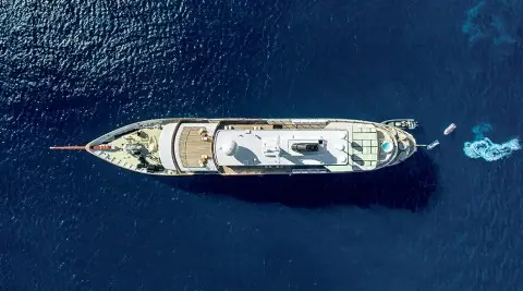 Top-down view of Chakra luxury yacht sailing vessel on deep blue water