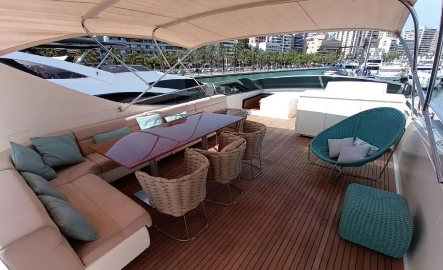 Miraval yacht deck at sunset with seating areas and blue cushions