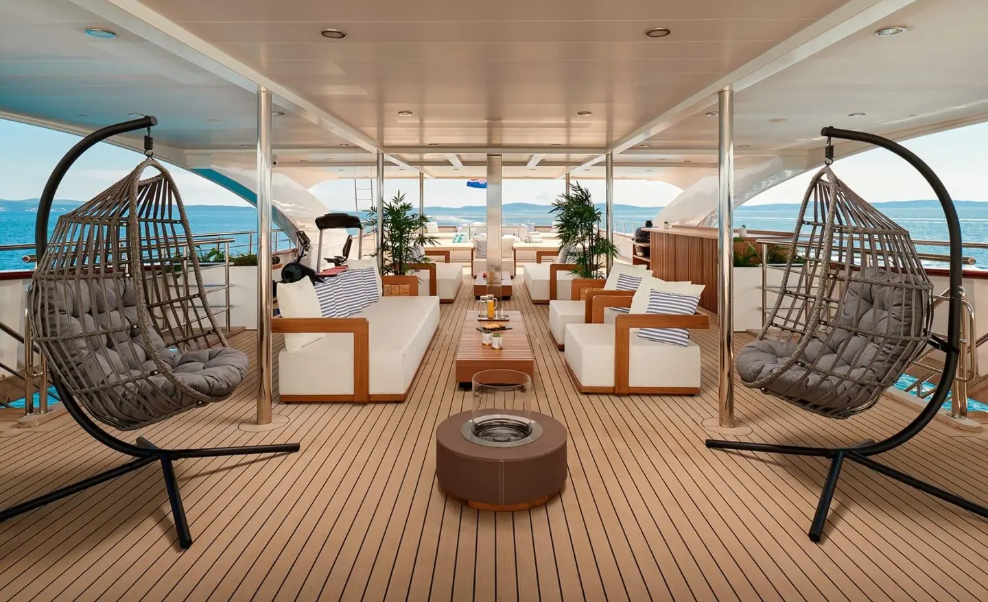 Ohana yacht sundeck with seating and sun loungers under shade, docked