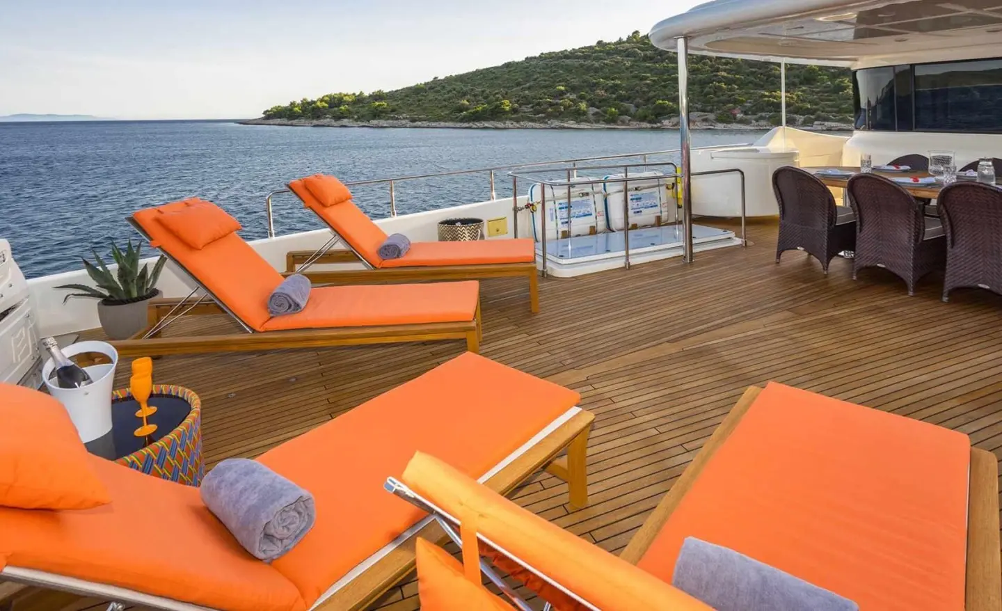 Seventh Sense yacht sun deck with orange loungers and ocean view