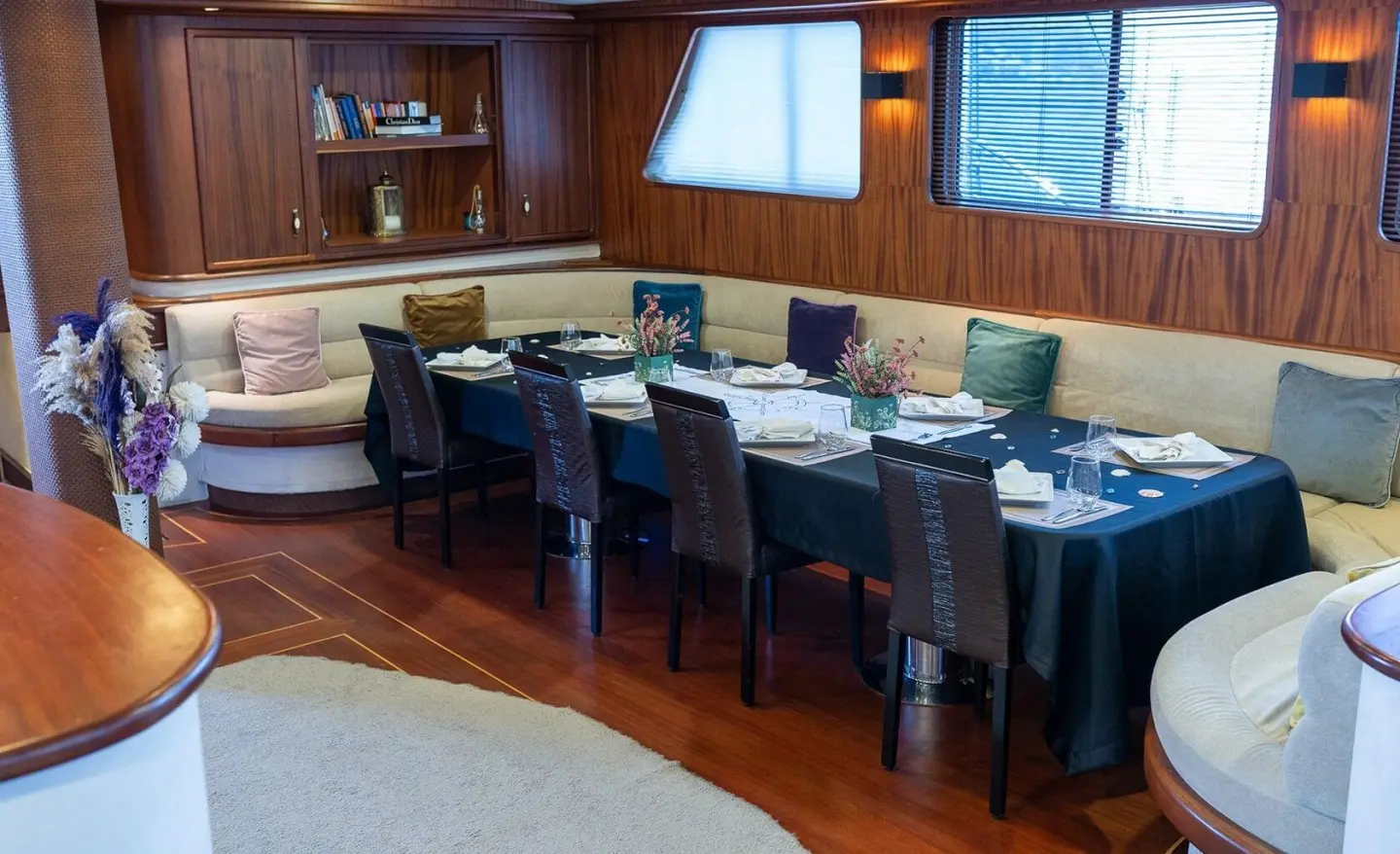 Nevra Queen yacht charter interior with a long wooden bar and bar stools