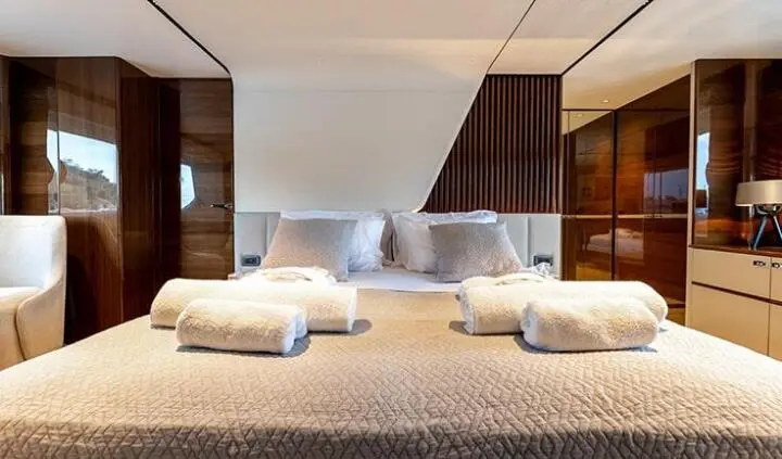 Master cabin with king bed, white linens, and ensuite layout on Vista yacht