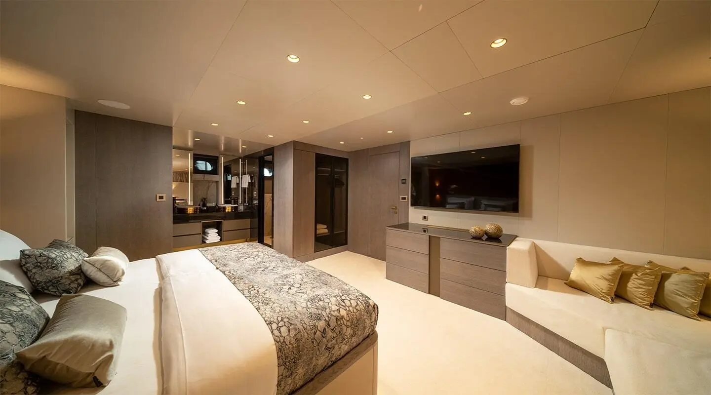 Interior of Nocturno luxury yacht with bed, seating, and modern kitchenette