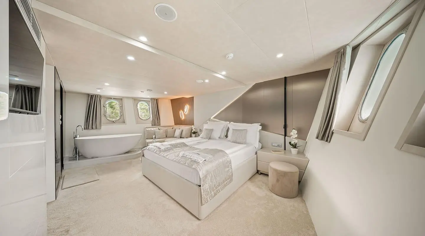 Interior of Cristal yacht with large bed, neutral tones, modern decor