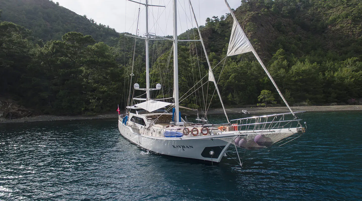 Kayhan 3 luxury gulet sailing at sunset, anchored in calm turquoise waters