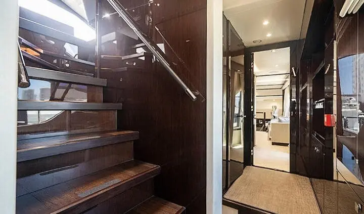 Queen size bed with dark wood headboard, ensuite doorway on cabin deck