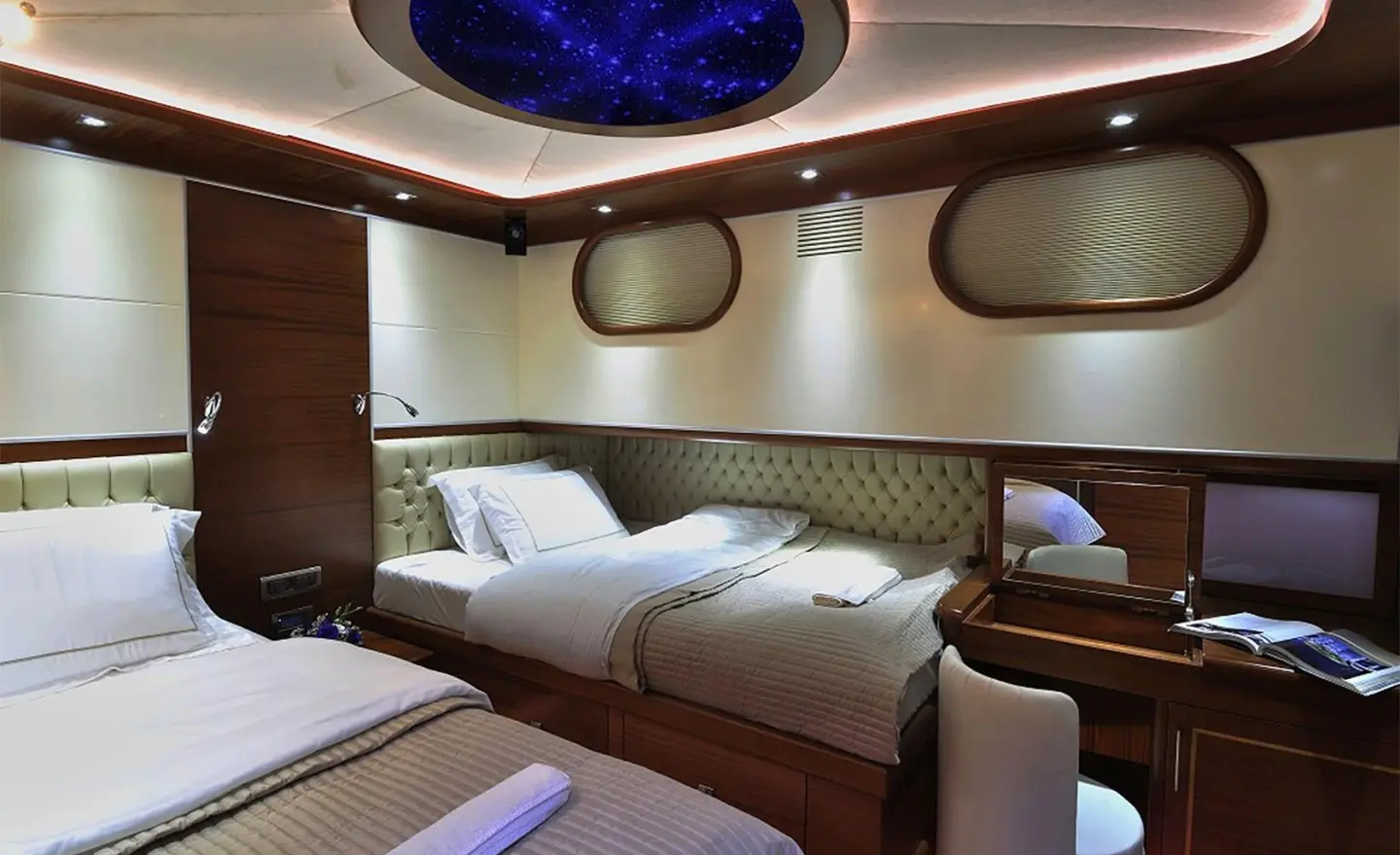 Dolce Mare yacht interior cabin with two single beds and porthole windows