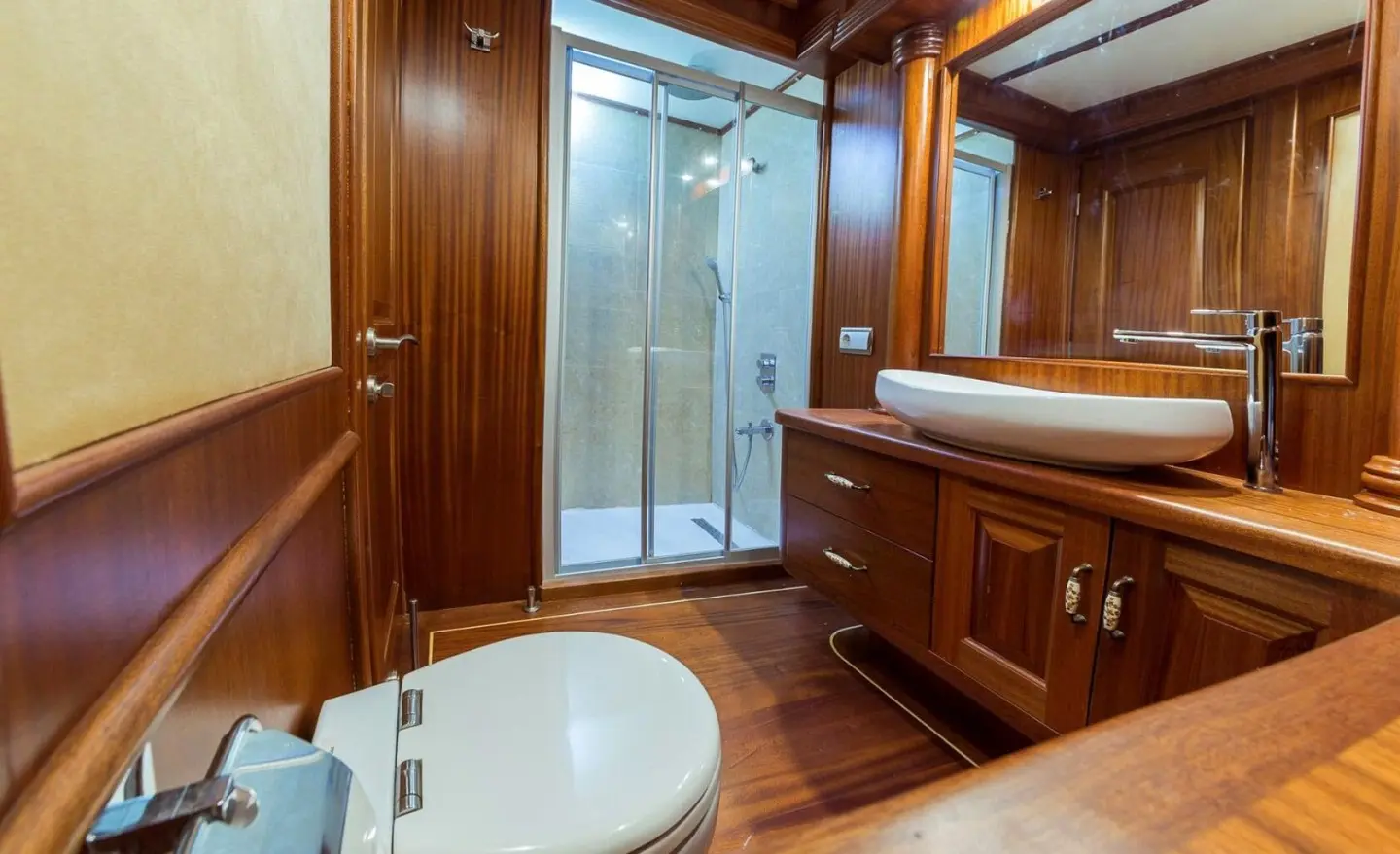 Luxurious yacht Halcon Del Mar interior with wood paneling and glass door