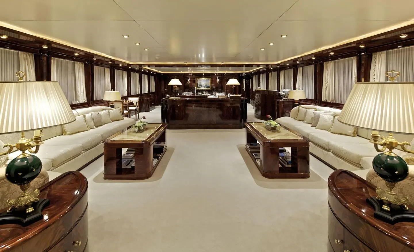 Luxurious yacht salon aboard O'Rion, polished wood, couches, and soft lighting