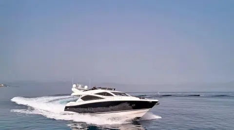Yacht M Five cruising on calm blue water with clear sky