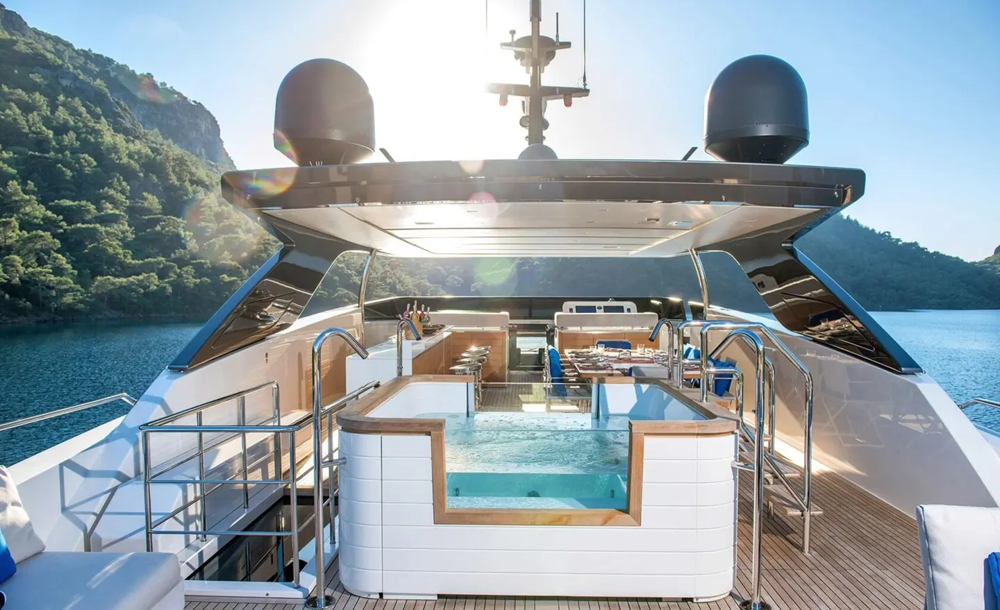 Morning Star yacht deck with pool, sun loungers, and blue seating under clear sky