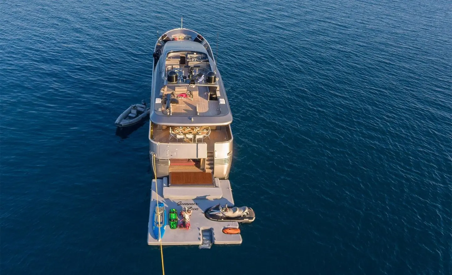 Overhead view of Summer Fun yacht at sea with open deck seating and swim platform