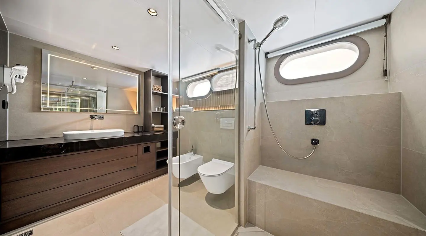 Deck view of Anima Maris: glass doors, seating, and modern helm area