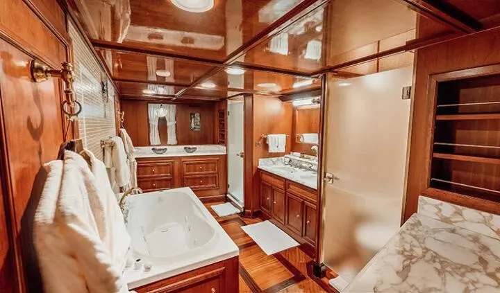 Seagull II master cabin with king bed, wood cabinetry, and ensuite bathroom