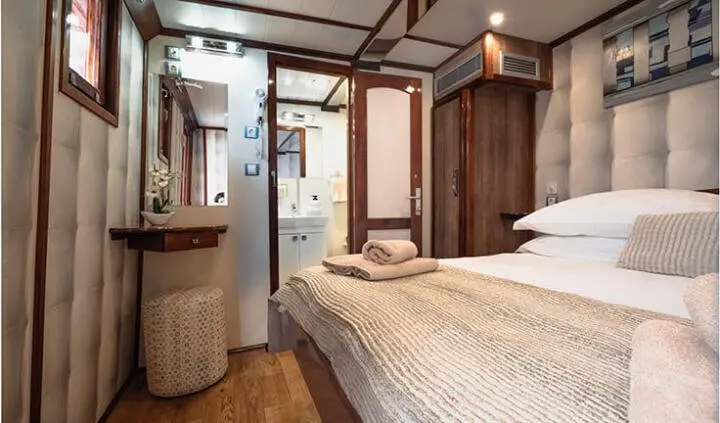 Mendula yacht cabin with two beds, wood cabin, ensuite area visible