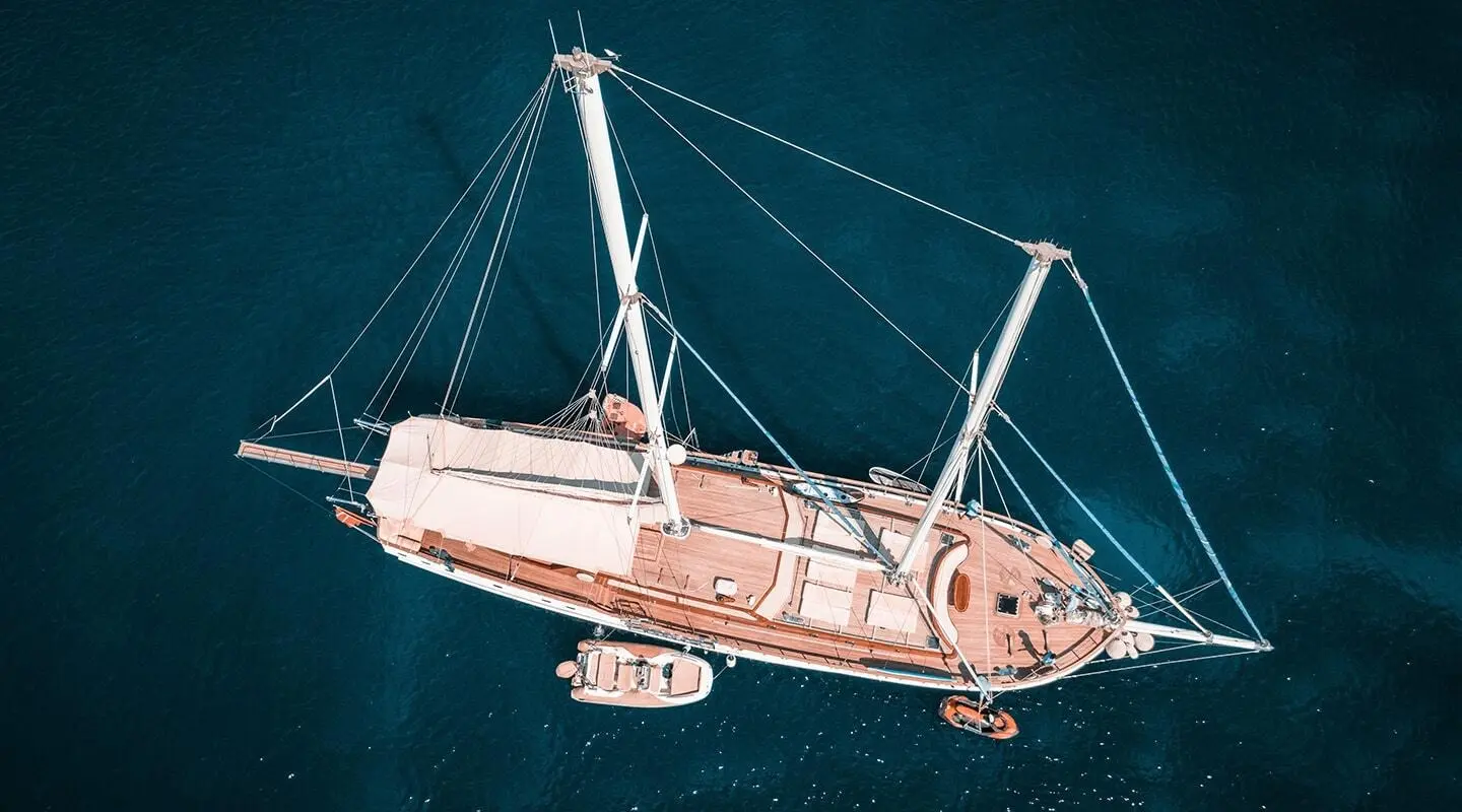 Small luxury sailing yacht Wicked Felina anchored at sunset, calm sea