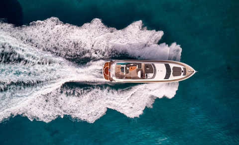 Overhead view of the white yacht M Five cruising in clear blue sea